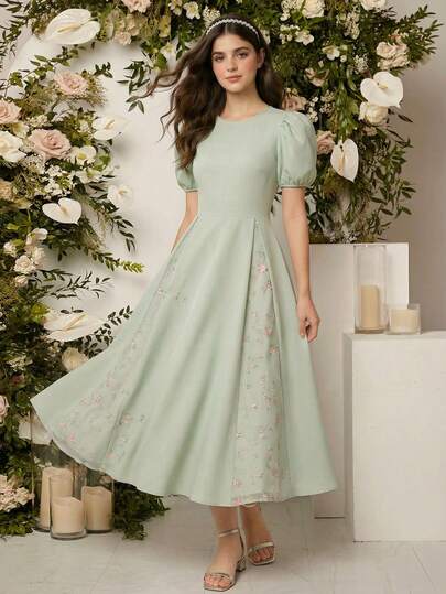 一件优雅的圆领泡泡袖连衣裙，后背拉链，网纱刺绣下摆，适合少女穿着，可用于休闲外出、聚会、派对、春夏等场合。