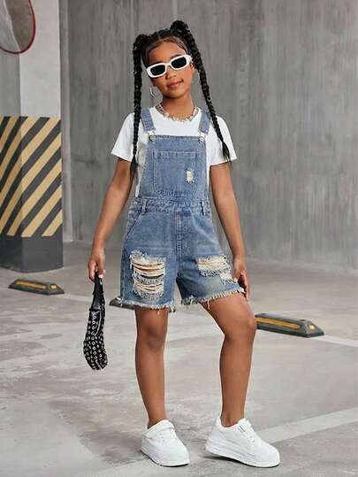 Vintage Denim Jumpsuit Shorts For Teenage Girls, Casual Street Style Recommended. Distressed Denim Blue With Faded Wash, Natural Ripped Thighs For Relaxed Look. Classic Adjustable Suspenders And Buttons, Front Pockets And Side Pockets. Retro And Practical For Daily Wear With White T-Shirt And Canvas Shoes, Back To School Look. Pair With Floral Camisole And Straw Bag For Casual Yet Chic Date Outfit.