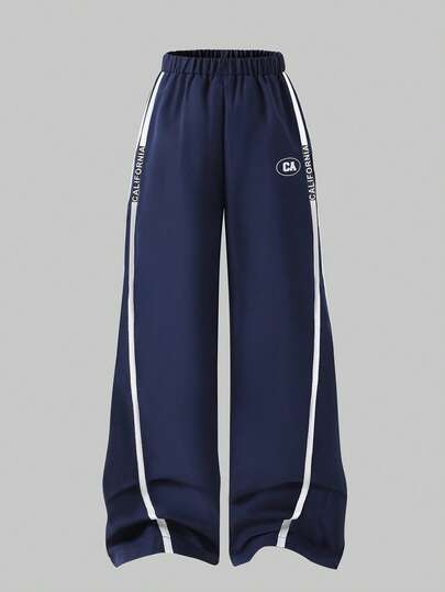 Casuvi Kids Loose Fit Navy Blue Casual Sports Pants For Tween Boywith Two White Stripes On Sides, "CALIFORNIA" Text, And Oval "CAx" Logo Graphic, Suitable For School, Sports, And Casual Weekends