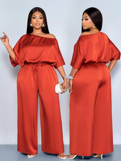 SOLERSUN 大码春夏新款亮面缎面不对称领口宽松蝴蝶结装饰上衣搭配松紧腰裤两件套。适合日常休闲穿着、聚会、约会、情人节、鸡尾酒会、毕业派对、旅行、海滩度假、新年音乐节、嘉年华、婚礼季以及宾客着装。性感、优雅、简约、时尚的女装。