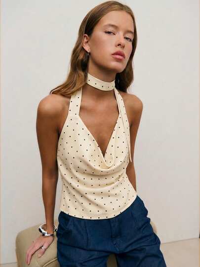 Nöista This Satin Halter Top Features A Deep Draped Neckline And Playful White Polka Dots On Glossy Brown Fabric. Ideal For Festive Winter Nights, Christmas Dinners, Or New Year Celebrations, It Blends Retro Charm With Party-Ready Style For Women's Winter Outfits.
