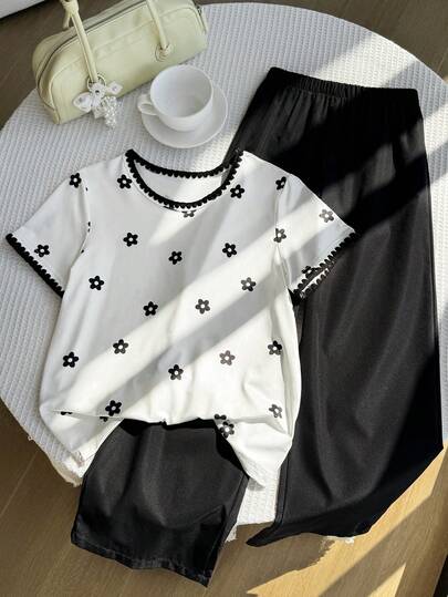 SHEIN Girls' Versatile Casual 2 Pieces Set: White Floral Top & Black Pants Soft, Stylish Outfit Perfect For Daily School, Weekend Outings, Family Gatherings Or Casual Hangouts. Features Delicate Details, Comfy Fabric & Easy-To-Match Design-Ideal For All Relaxed Occasions!