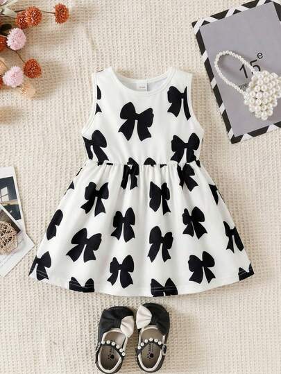 SHEIN Playful Pals 1 pieza Vestido de niña pequeña de estilo elegante y dulce con estampado de lazo en blanco y negro, vestido de línea A sin mangas con cuello redondo, vestido de princesa suave para fiesta, cumpleaños, boda, playa, vacaciones, sesión de fotos, uso diario en verano y primavera