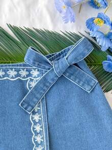 Soleia Women's Floral Print Wrap Tie Casual Denim Mini Skort Women's Mid-Blue Denim Skort With White Floral Embroidery And Bow Side Detail Summer Casual A-Line Mini Skort Summer Outfits Summer Outfits For Women Spring Clothing Spring Break Outfits Summer Holiday Outfits Summer Vacation Outfits Beach Vacation Outfits For Women Casual Outfit For Women  Floral Skort Blue Skort - Medium Wash - View 6