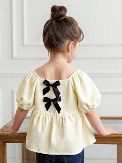 Elladie kids Young Girls Cute Sweet Refreshing Puff Sleeve Black Bow Decor Wide Collar Short Sleeve Half-Placket Casual Minimalist Lightweight Summer Shirt In Pale Yellow Girl Bow Shirt Little Girl Blouse Girls Summer Blouse Toddler Girls Vintage Style Blouses For Kids Bow Shirt For Girls Cute Tops For Kids Girl Summer Tops Kids Girl
