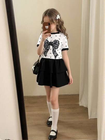 女童（小号）春夏T恤套装，黑色蕾丝蝴蝶结数码印花图案，白色拼接黑色短袖圆领T恤上衣搭配黑色纯色双层蛋糕裙，两件套，适合女孩日常简约、休闲、优雅的通勤穿着，也适合日常上学、外出、度假、聚会、节日等场合，春夏皆宜。