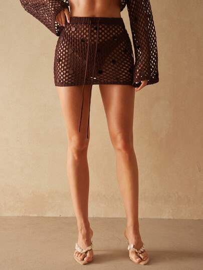 Silquee This Women's Coffee-Brown Semi-Transparent Knit Sequined Openwork Crochet Mini Skirt Is Suitable For Outdoor Wear, Casual Vacations, Spring/Summer Carnivals, Bohemian Styles, And Beach Vacations. It's Perfect For Beach Holidays, Pool Parties, And Other Occasions. A Brown Openwork Sequined Knit Mini Skirt, Perfect For A Fashionable Party Look.