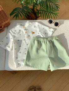SHEIN 2pcs/Set Young Boy Cartoon Coconut Tree Pattern Mandarin Collar Short Sleeve Half-Zip Pullover Top And Elastic Waist Solid Color Shorts,Kids - White - View 6