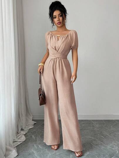 Rafferiza Elegant Khaki Jumpsuit For Women, Featuring A Round Neck, Knotted Waist, And Wide-Leg Design With Wooden Bead Embellishments. This Long Summer Jumpsuit Is Perfect For Women's Holidays, With Vintage Wooden Bead Details, Puff Sleeves, Knotted Straps, And Textured, Pleated Fabric.