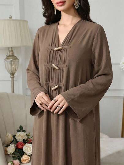 Veilorie Dam enfärgad långärmad abaya med lös passform och hornknappar