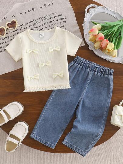 SHEIN 2pcs Baby Girls' Fashion Minimalist Bohemian Style Short Sleeve T-Shirt With 3D Bow & Tassel Decor, Paired With Elastic Waist Denim Pants