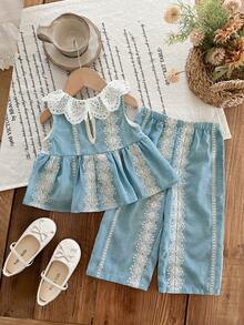 SHEIN LMoss Kids 这款女婴两件套可爱百搭的夏季度假风碎花荷叶边上衣和裤子套装，舒适休闲，时尚百搭，适合日常穿着。完美适用于秋冬季生日派对、晚宴、演出、婚礼、洗礼、开幕式、室内外活动、日常生活、运动、玩耍、聚会、拍照、度假等场合。也适合春夏季穿着。 - 藍色 - 查看 2