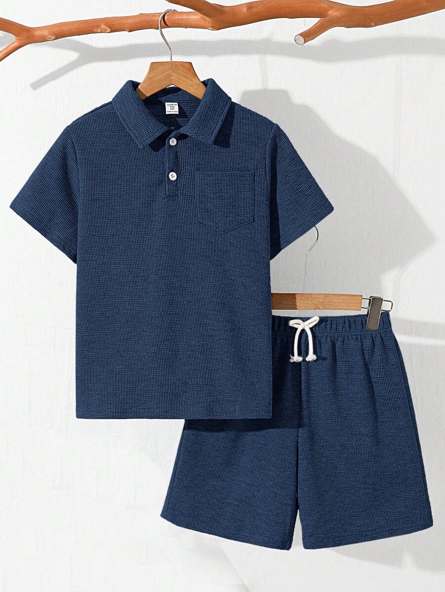 SHEIN Bộ 2 món cho bé trai tuổi teen, gồm áo thun cổ polo tay ngắn màu trơn dáng rộng và quần short, thích hợp đi làm, đi học, mặc thường ngày, chơi thể thao, mùa xuân/hè. - Màu xanh hải quân - Xem 1
