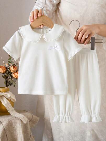 SHEIN Baby Girl Spring/Summer Knitted Double-Sided Brushed Ribbed Collar Lace Trim Bow Decor Soft Short Sleeve Top And 3/4 Pants 2-Piece Set, Pure White, Casual, Fashionable, Sleepwear, Homewear