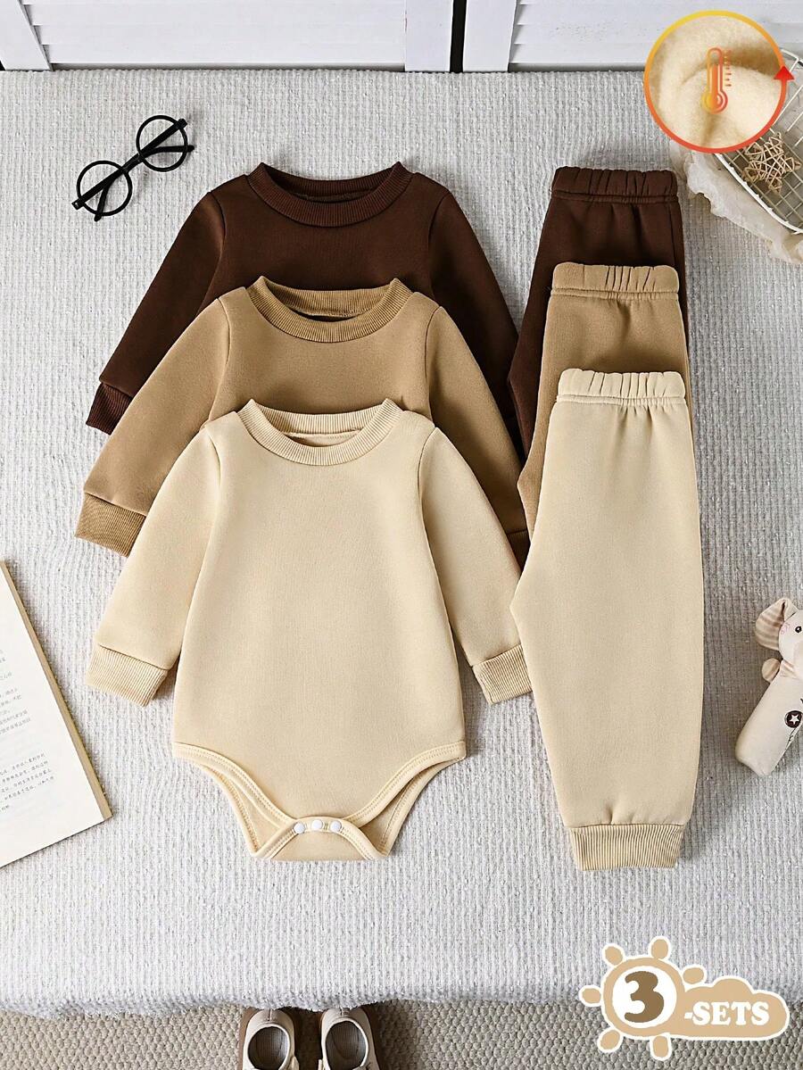 SHEIN Vintaside Kids Bộ đồ liền thân 3 món cổ tròn tay dài màu trơn cho bé trai, có sẵn màu đen, trắng và xám, kiểu dáng thời trang, họa tiết đơn giản với màu trơn thanh lịch, dáng rộng phù hợp với nhiều dáng người khác nhau. Bộ đồ gồm 3 món bao gồm áo liền thân và 3 quần dài không cạp, phù hợp cho nhiều dịp khác nhau: Thích hợp cho các hoạt động ngoài trời, thường ngày và tự do; Thích hợp cho các hoạt động giải trí tại nhà, thoải mái và thú vị; Thích hợp cho các môn thể thao, linh hoạt và năng động. - Nhiều màu - Xem 1