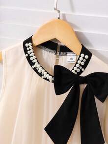 一件女童优雅奢华网纱无袖A字连衣裙，配有可拆卸珍珠领、可拆卸蝴蝶结和撞色下摆，纯色甜美连衣裙，适合旅行、派对、度假、海滩和户外活动穿着。 - 杏色 - 查看 7