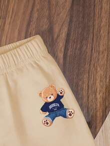 SHEIN Playful Pals 这款男婴时尚舒适休闲圆领短袖T恤套装，采用可爱小熊和条纹印花设计，宽松圆领，适合春夏穿着，休闲街头风、户外运动、上学、聚会等场合，也是一份贴心的礼物。 - 杏色 - 查看 4