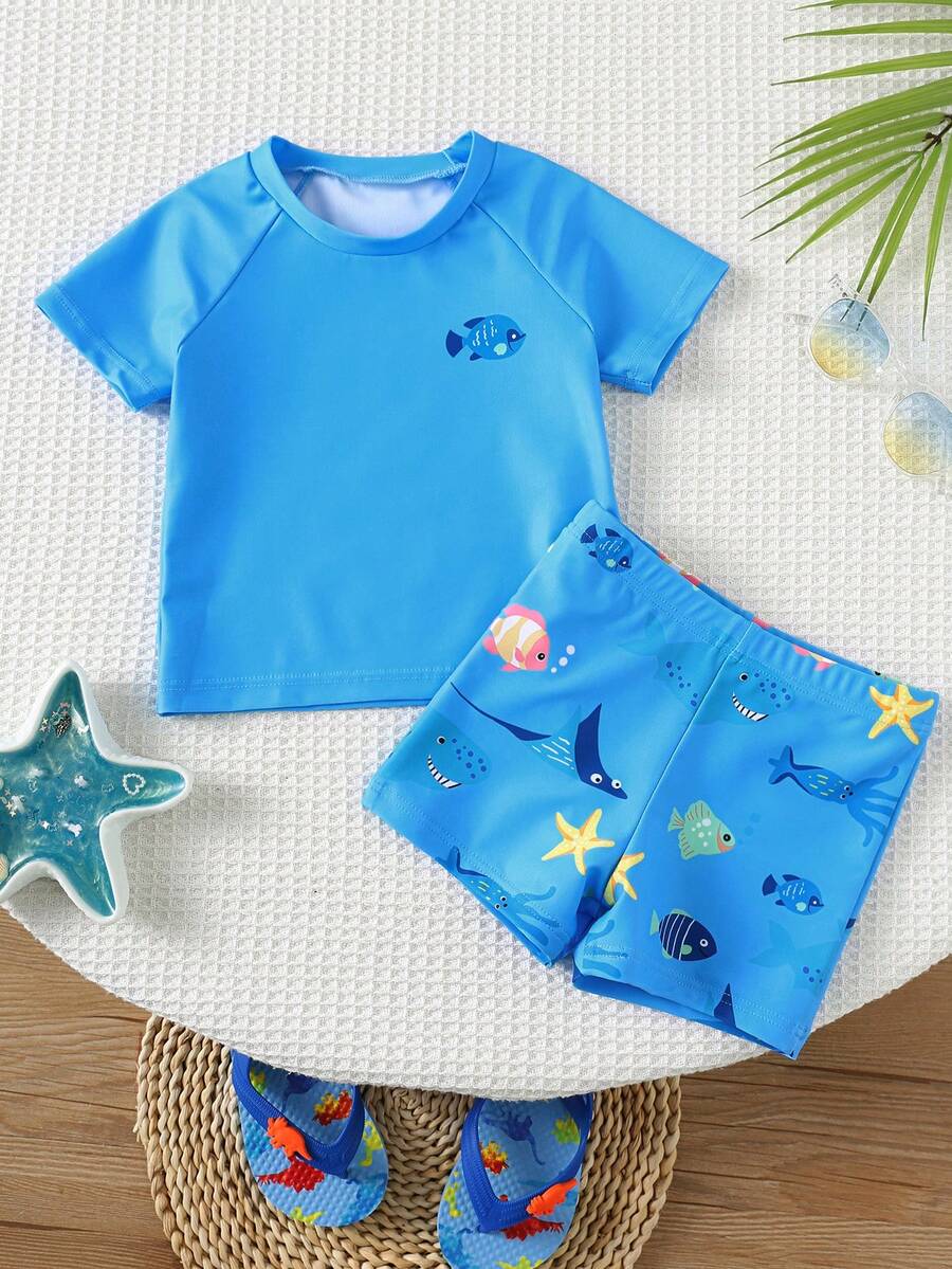 SHEIN Bộ đồ bơi ngắn tay cổ tròn ôm sát in hình cá mập hoạt hình dễ thương cho bé trai, thích hợp cho mùa hè. - Nhiều màu - Xem 1