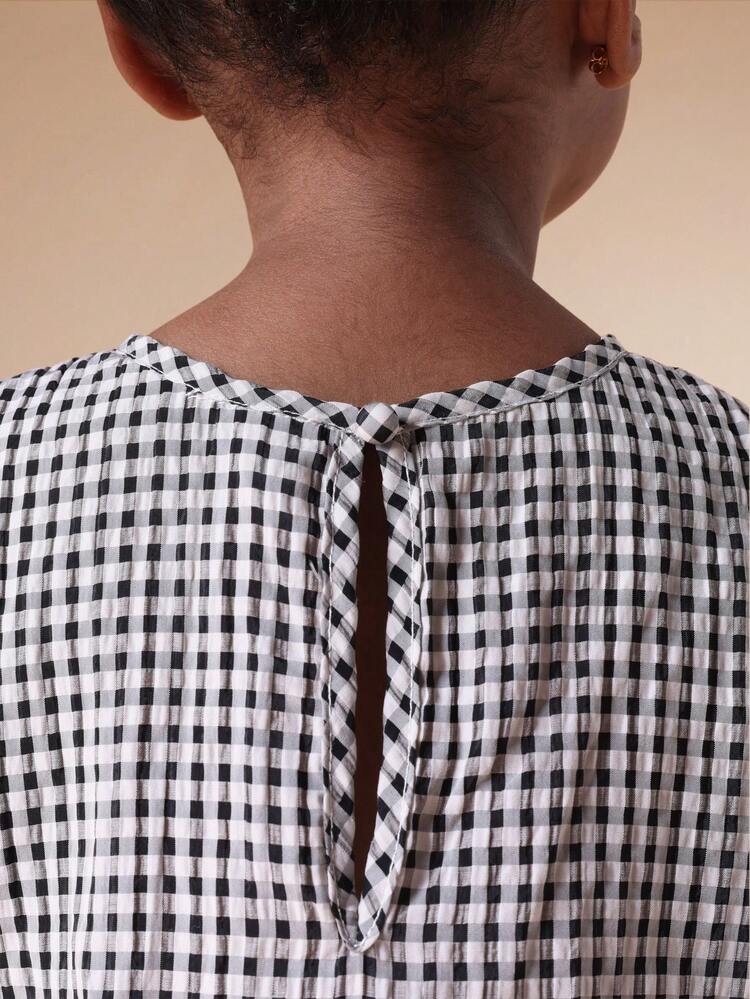 Ensemble débardeur péplum à carreaux  et pantalon palazzo