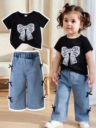 SHEIN 2pcs Baby Girls' Summer Fashion Street Casual Black Round Neck Short Sleeve T-Shirt With White Lace Bow Print On Chest, Paired With Blue Pants And Black Ribbon Bow Decor On Side, Suitable For Street, School And Daily Wear