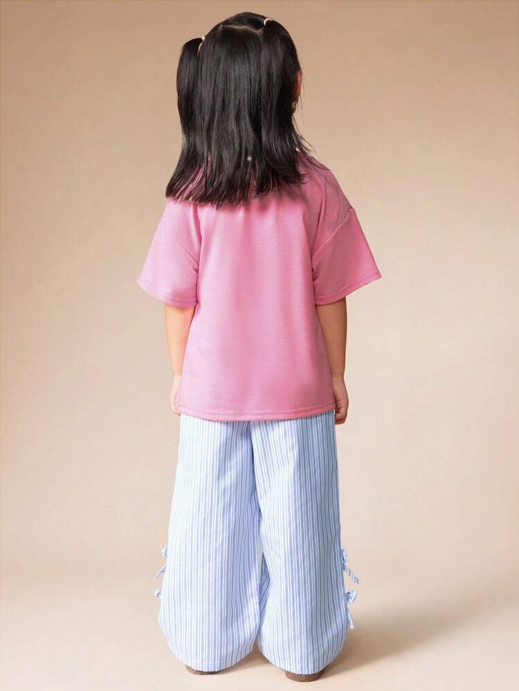 Koszulka z nadrukiem kiwi i zestaw ze spodniami palazzo w paski