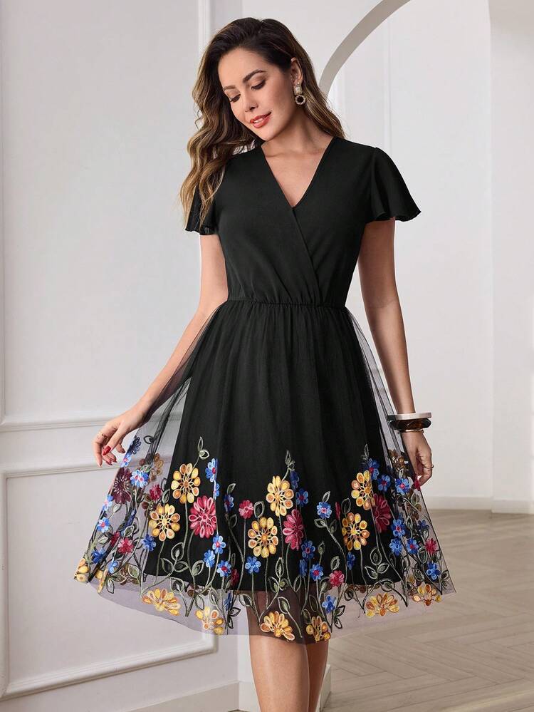 This Elegant Women's Dress Features A Classic Pure Black Base, Adorned With Colorful Floral Mesh Embroidery At The Hem, Creating A Contrasting And Romantic Atmosphere. The Floral Pattern Is A Vibrant Wildflower Embroidery, Rich In Detail And Full Of Lively Charm. The Design Includes A V-Neck With Short Flutter Sleeves, A Pearl-Buckled Waist Belt, And A Mesh Skirt. The Draping And Breathable Fabric Is Suitable For Various Occasions, Showcasing Elegant Sophistication. Perfect For Summer, It's Ideal For Romantic Dates, Casual Gatherings, Or Evening Banquets. The Pure Black Base Conveys Elegance While The Colorful Floral Embroidery Showcases Fashionable Taste, Making It A Versatile And Stylish Choice For Your Summer Wardrobe.