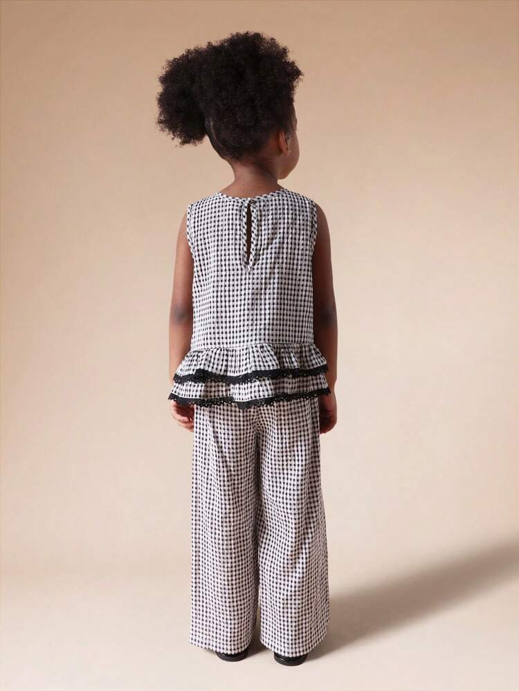 Ensemble débardeur péplum à carreaux  et pantalon palazzo