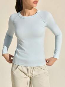 Exploreva Damska koszulka sportowa z długim rękawem w jednolitym kolorze, bezszwowa koszulka z długim rękawem i okrągłym dekoltem, damska koszulka fitness o dopasowanym kroju z długim rękawem - Niebieski - Zobacz 1