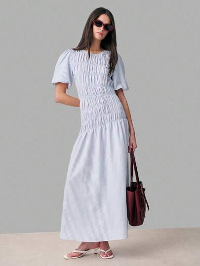 Nöista This Light Blue Striped Dress, Puff Sleeves, A Ruched Bodice With Smocking Details, And A Flowing Asymmetrical Shape. Women, Spring, Summer Outfit.