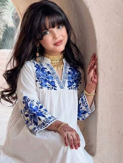 Tween Girls Pink Dress, Made Of Soft Fabric For Comfortable Wear. The Dress Body Is In Soft Pink Tone, With White Ruffle Trim On The Shoulders Decorated With Blue Flowers, Adding A Touch. The Dress Al