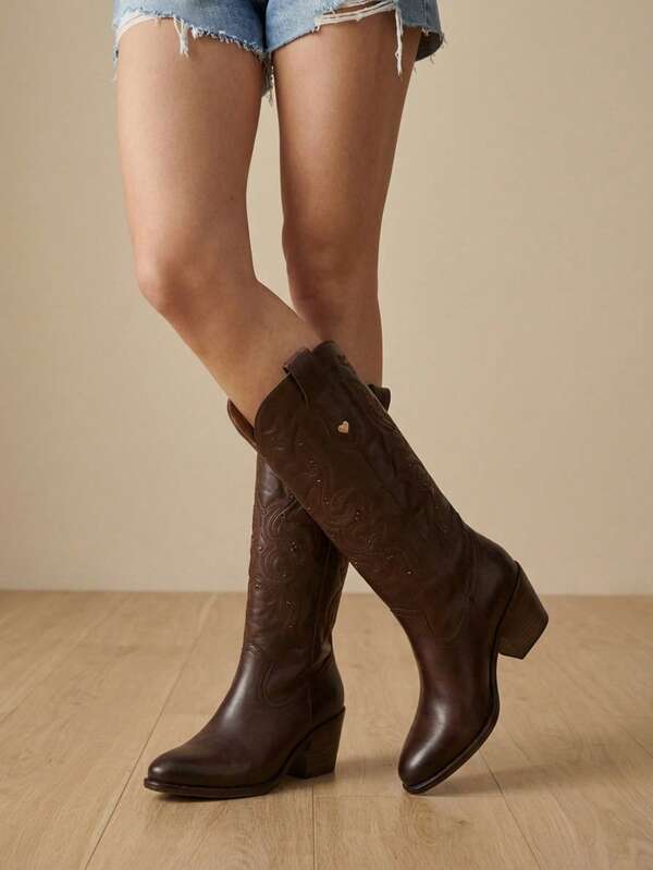 Botas altas de tipo cuero repujado marrón oscuro para mujer, estilo vaquero, con tacón grueso.
Elegantes botas vaqueras marrones bordadas para mujer con detalle de tachuela en forma de corazón.
Botas altas clásicas de cuero marrón para mujer con costuras estilo vaquero y tacón ancho.