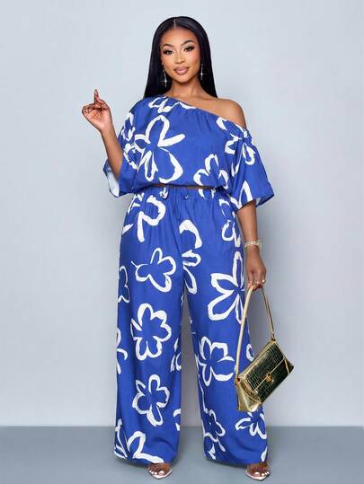 SOLERSUN Conjunto de dos piezas de blusa de manga corta con cuello asimétrico y pantalones de pierna ancha con cintura elástica para mujer de talla grande, con estampado floral aleatorio, estilo bohemio, adecuado para uso diario, Día de San Patricio, Pascua, festivales de música, trébol de cuatro hojas, estilo callejero, vacaciones en la playa, picnic, viajes diarios. Elegante y versátil, con un toque moderno, también adecuado para la temporada de bodas.