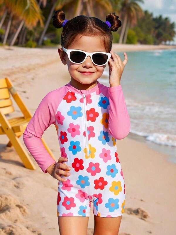 色彩鲜艳的花卉印花撞色插肩袖连体泳衣，带拉链，适合年轻女孩夏季度假和海滩穿着。