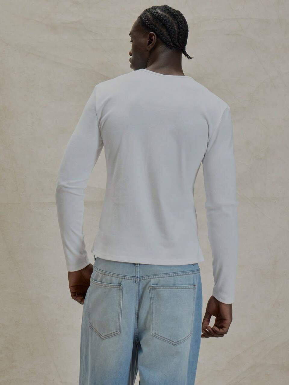 Camiseta básica de manga larga, cuello ligeramente alto, estilo ajustado y musculoso, color liso, esencial para un armario cápsula, ideal para capas en primavera y verano