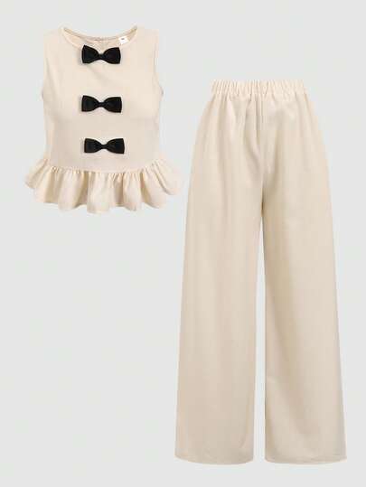 少女圆领荷叶边蝴蝶结装饰无袖上衣搭配阔腿裤，休闲日常穿搭