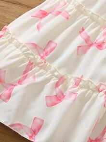 Elladie kids Đầm kiểu bánh kem 3D dễ thương cho bé gái, đầm đồng phục học sinh, thân đầm màu be nhạt, in họa tiết nơ hồng, cổ vuông, tay ngắn phồng, nơ hồng lớn trang trí ngực, viền bèo nhiều lớp, ngọt ngào và đáng yêu, toát lên vẻ ngây thơ của trẻ nhỏ. - Nhiều màu - Xem 3