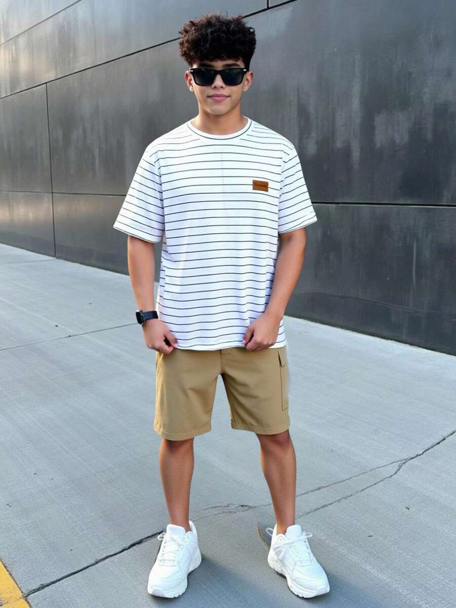 SHEIN 男童休闲短袖上衣短裤套装(两件套),街头风、朋克摇滚风、学院风,适合春夏、派对、音乐节等场合,英文涂鸦印花和撞色设计 - 彩色 - 查看 1