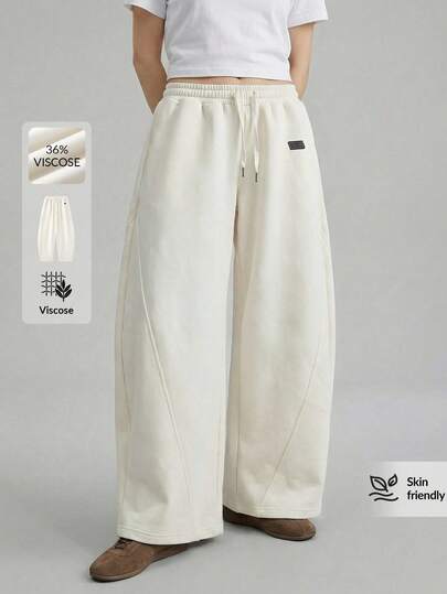 Ontre 2026春夏女装梭织条纹浪漫情人节杏色喇叭裤，宽松版型，适合独立日、都市时尚、简约通勤穿着。