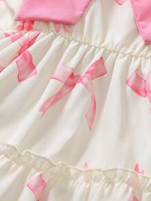 Elladie kids Đầm kiểu bánh kem 3D dễ thương cho bé gái, đầm đồng phục học sinh, thân đầm màu be nhạt, in họa tiết nơ hồng, cổ vuông, tay ngắn phồng, nơ hồng lớn trang trí ngực, viền bèo nhiều lớp, ngọt ngào và đáng yêu, toát lên vẻ ngây thơ của trẻ nhỏ. - Nhiều màu - Xem 6