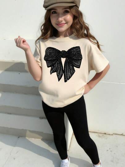 SHEIN Sparklyn Conjunto de camiseta y leggings de estilo casual y fresco para primavera y verano, con decoración de lazo negro brillante y estampado gráfico minimalista, ideal para uso diario y cómodo, adecuado para niñas preadolescentes en primavera, verano y otoño