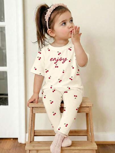 SHEIN Cream White, Cute Mini Cherry Minimalist Sweet Letter Pattern, Baby Girl Casual Loose Round Neck Short Sleeve T-Shirt And Leggings Set, Suitable For Spring/Summer Daily Wear, Farm, Picnic, Outing, Home, Vacation