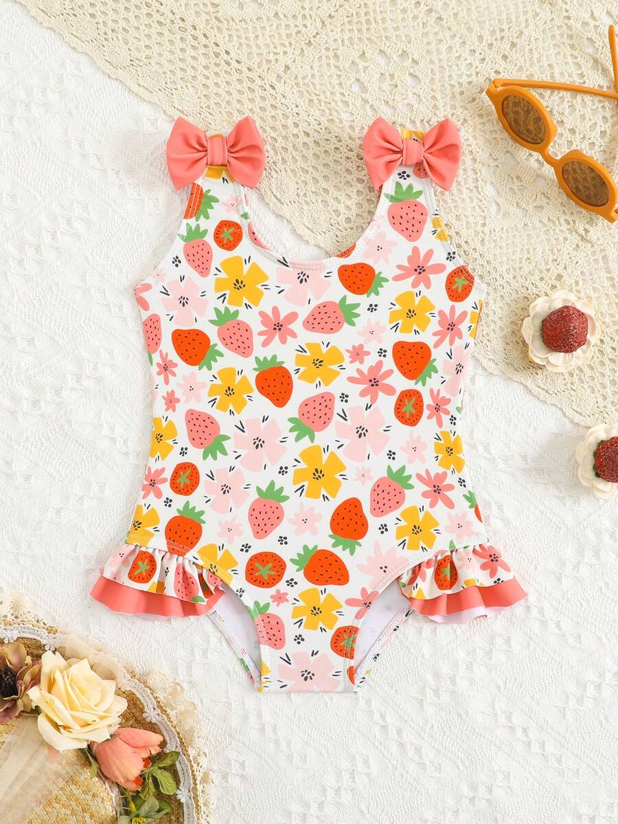 Bộ đồ bơi liền thân cho bé gái in hình dâu tây và hoa, phối màu tương phản với nơ và bèo nhún, thích hợp cho kỳ nghỉ hè ở bãi biển. - Nhiều màu - Xem 1