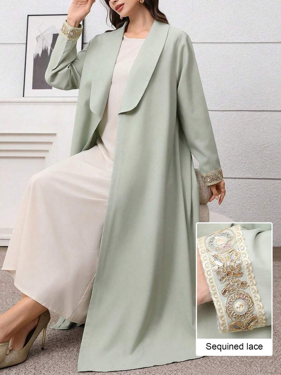 Al Najma Áo Abaya sang trọng, thanh lịch với cổ áo màu xanh lá cây, phối ren vàng, thích hợp cho các buổi đi chơi và hẹn hò.