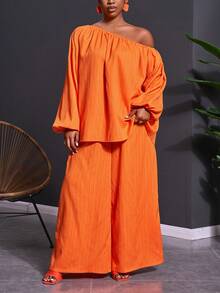 Veslaya Bộ trang phục 2 mảnh dành cho nữ cỡ lớn mùa Xuân & Hè 2026, thích hợp cho các lễ hội âm nhạc, lễ Phục Sinh, phong cách miền Tây, du mục, tiệc sinh nhật, lễ tốt nghiệp, phong cách sinh viên, mặc hàng ngày, cơ bản, đa năng, thường ngày, kỳ nghỉ, du lịch biển, tắm nắng, xu hướng thịnh hành, cao cấp, thanh lịch. Áo tay dài tay phồng dáng chữ A và quần ống rộng, chất liệu vải nhăn màu cam, kiểu dáng bất đối xứng vai và quần ống rộng, gồm áo và quần ống rộng. - trái cam - Xem 4