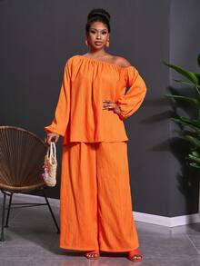 Veslaya Bộ trang phục 2 mảnh dành cho nữ cỡ lớn mùa Xuân & Hè 2026, thích hợp cho các lễ hội âm nhạc, lễ Phục Sinh, phong cách miền Tây, du mục, tiệc sinh nhật, lễ tốt nghiệp, phong cách sinh viên, mặc hàng ngày, cơ bản, đa năng, thường ngày, kỳ nghỉ, du lịch biển, tắm nắng, xu hướng thịnh hành, cao cấp, thanh lịch. Áo tay dài tay phồng dáng chữ A và quần ống rộng, chất liệu vải nhăn màu cam, kiểu dáng bất đối xứng vai và quần ống rộng, gồm áo và quần ống rộng. - trái cam - Xem 3