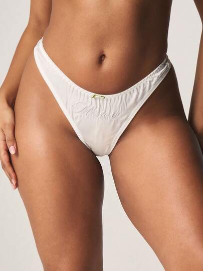 MISSGUIDED White Satin Slogan Embossed Thong Panty With Bow Accent And Ruched Design For Intimate Occasions