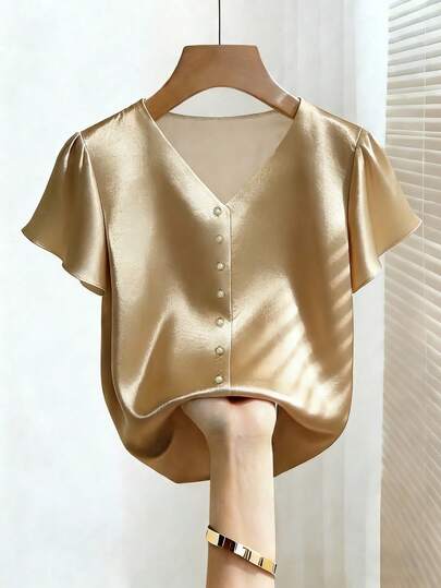 Franclia [Satin Pearl Button Shirt] The Satin Fabric Has A Glossy Sheen, Making The Shirt Look Luxurious And Not Cheap. The V-Neck Elongates The Neckline, And The Pearl Buttons On The Front Add Refined Details Without Being Ostentatious. The Puff Short Sleeves Soften The Shoulder Line, And The Loose Fit Conceals Flaws. Pair It With A High-Waisted Skirt For A Gentle, Elegant Look, Or With Suit Pants For A Polished, Sophisticated Work Outfit. Silk Blouse Gold Blouse Satin Tops For Women Silk Tops Gold Shirt