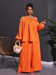 Veslaya Bộ trang phục 2 mảnh dành cho nữ cỡ lớn mùa Xuân & Hè 2026, thích hợp cho các lễ hội âm nhạc, lễ Phục Sinh, phong cách miền Tây, du mục, tiệc sinh nhật, lễ tốt nghiệp, phong cách sinh viên, mặc hàng ngày, cơ bản, đa năng, thường ngày, kỳ nghỉ, du lịch biển, tắm nắng, xu hướng thịnh hành, cao cấp, thanh lịch. Áo tay dài tay phồng dáng chữ A và quần ống rộng, chất liệu vải nhăn màu cam, kiểu dáng bất đối xứng vai và quần ống rộng, gồm áo và quần ống rộng. - trái cam - Xem 5