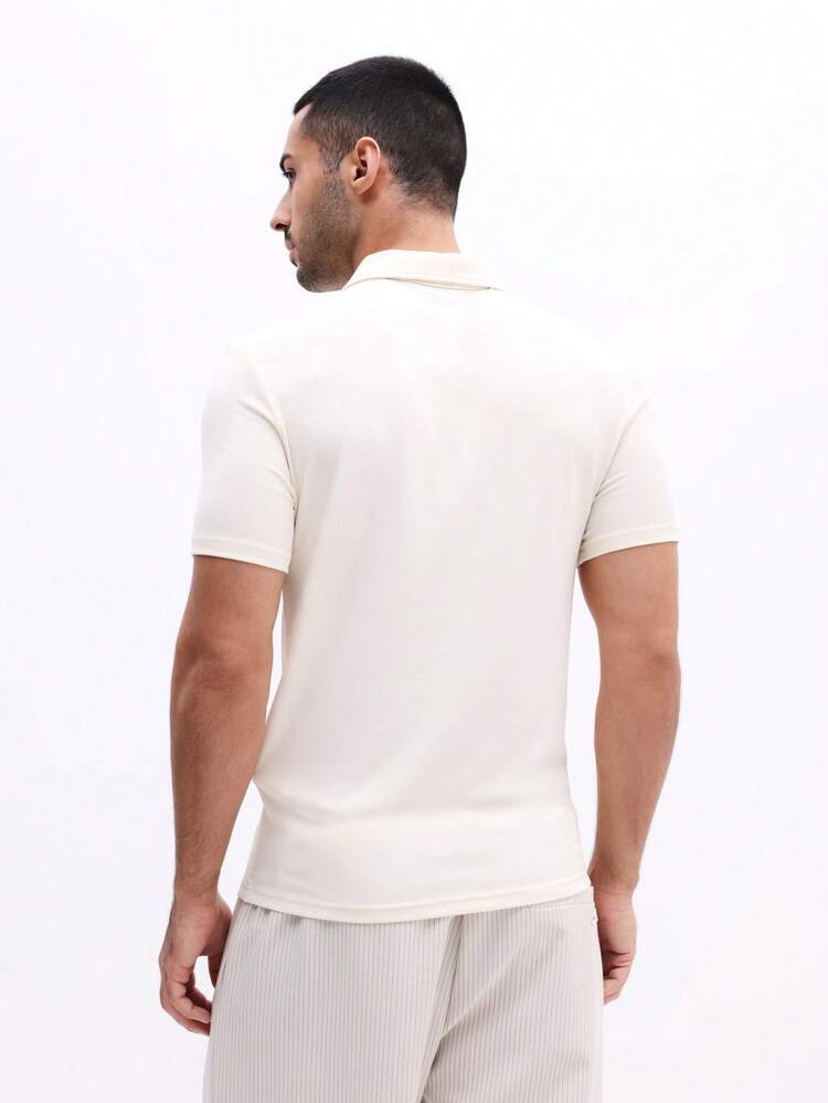 Polo con cremallera de un cuarto y estampado en el pecho