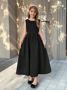 Đầm bé gái tuổi teen cổ tròn, kiểu dáng tối giản, eo xếp ly, chân váy xòe nhẹ với nơ trang trí phía sau, thích hợp cho kỳ nghỉ. - màu đen - Xem 2